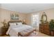 Bedroom with wooden furniture, a comfortable bed, and a large window with backyard views at 5080 Forest Dr., Loris, SC 29569