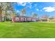 Front view of a red brick ranch-style home with a large green lawn at 5080 Forest Dr., Loris, SC 29569