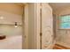 View of a bathroom through a doorway with a bedroom visible in the background at 604 Stableford Ct., Myrtle Beach, SC 29577