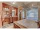 Elegant bathroom featuring dual vanities, a jetted tub, and ornate cabinetry at 604 Stableford Ct., Myrtle Beach, SC 29577