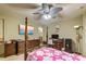 Bright bedroom with pink floral bedspread, desk, and wooden furniture at 604 Stableford Ct., Myrtle Beach, SC 29577