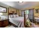Cozy bedroom with wooden four-poster bed, bedside tables, and patterned curtains at 604 Stableford Ct., Myrtle Beach, SC 29577