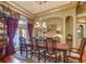 Elegant dining room featuring a grand chandelier, ornate decor, and large windows at 604 Stableford Ct., Myrtle Beach, SC 29577