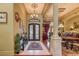 Welcoming entryway with decorative iron front door, tiled floor, and view of the dining area at 604 Stableford Ct., Myrtle Beach, SC 29577