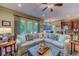 Cozy living room with sectional sofa, fireplace, and a glimpse of the kitchen at 604 Stableford Ct., Myrtle Beach, SC 29577