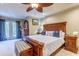 Main bedroom with large bed, ceiling fan, sitting area, and balcony access at 604 Stableford Ct., Myrtle Beach, SC 29577