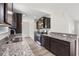 Kitchen with dark wood cabinets, granite countertops, and stainless steel appliances at 627 Snowy Owl Way, Conway, SC 29527