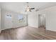 Bright living room with wood-look flooring, a ceiling fan, and an open doorway at 627 Snowy Owl Way, Conway, SC 29527