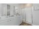 Clean and modern bathroom with white vanity, double sinks, and a glass shower at 700 Wallace Dr., Little River, SC 29566