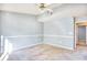 Spacious bedroom with carpeted floor, ceiling fan, chair rail, and an open doorway at 978 Castlewood Dr., Conway, SC 29526