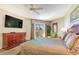Bedroom featuring a king-size bed, balcony access, and a large TV at 9994 Beach Club Dr. # 1604, Myrtle Beach, SC 29572