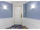 White front door of condo with blue walls, white trim, and patterned carpet at 9994 Beach Club Dr. # 1604, Myrtle Beach, SC 29572