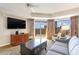 Living area with a large TV, comfortable couch, and access to the balcony at 9994 Beach Club Dr. # 1604, Myrtle Beach, SC 29572
