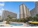 Resort-style pool area with palm trees and lounge chairs at 9994 Beach Club Dr. # 1604, Myrtle Beach, SC 29572