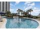 Large pool with a lazy river feature and palm trees at 9994 Beach Club Dr. # 1604, Myrtle Beach, SC 29572