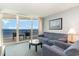 Living room with ocean view, comfortable seating, and balcony access at 107 Ocean Blvd. S # 507, Myrtle Beach, SC 29577