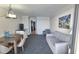 Living area with sofa, dining table, and view of the adjacent kitchen at 1105 S Ocean Blvd. # 830, Myrtle Beach, SC 29577