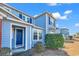Two-story light blue townhome with navy blue front door and landscaping at 1857 Culbertson Ave. # 1857, Myrtle Beach, SC 29577