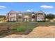 Attractive two-story brick condo building with balconies under a bright blue sky at 2005 Silvercrest Dr. # G-32, Myrtle Beach, SC 29579