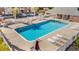 Community pool with lounge chairs, white picket fence, and adjacent condo building with parking at 2005 Silvercrest Dr. # G-32, Myrtle Beach, SC 29579