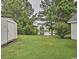Landscaped backyard with pond view and storage shed at 2707 Wood Creek Ln., Conway, SC 29527