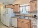 Galley kitchen with stainless steel appliances and light wood cabinets at 2707 Wood Creek Ln., Conway, SC 29527
