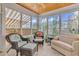 Relaxing sunroom with wicker furniture and a view of the garden at 317 Goddard Ln., Murrells Inlet, SC 29576
