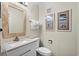Guest bathroom with white vanity, toilet and beach decor at 415 Ocean Creek Dr. # 2236, Myrtle Beach, SC 29572