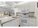 Updated kitchen boasts granite countertops, white cabinetry, and stainless steel appliances at 415 Ocean Creek Dr. # 2236, Myrtle Beach, SC 29572