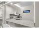 Bright kitchen with granite counters, white cabinets, and 