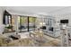 Bright living room with sliding glass doors to the balcony, comfortable seating, and TV at 415 Ocean Creek Dr. # 2236, Myrtle Beach, SC 29572