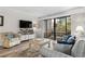 Welcoming living room with comfortable seating, sliding glass door to balcony, and coastal decor at 415 Ocean Creek Dr. # 2236, Myrtle Beach, SC 29572