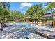 Inviting community pool with lounge chairs and brick patio at 415 Ocean Creek Dr. # 2236, Myrtle Beach, SC 29572
