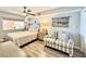 Bedroom with a queen-size bed, loveseat, and ceiling fan at 4800 S Ocean Blvd. # 611, North Myrtle Beach, SC 29582