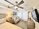 Bedroom with queen bed, loveseat, and closet at 4800 S Ocean Blvd. # 611, North Myrtle Beach, SC 29582