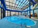 Indoor pool with glass roof and seating area at 4800 S Ocean Blvd. # 611, North Myrtle Beach, SC 29582