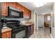Clean kitchen with black appliances and wood cabinets at 5200 N Ocean Blvd. # 1134, Myrtle Beach, SC 29577