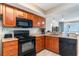 Well-equipped kitchen with granite counters and dark appliances at 5300 N Ocean Blvd. # 1011, Myrtle Beach, SC 29577