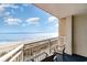 Oceanfront balcony view with chairs and railing at 5300 N Ocean Blvd. # 1011, Myrtle Beach, SC 29577