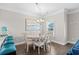 Bright dining room with round table and chairs, hardwood floors, and beachy decor at 6001 - 5326 S Kings Hwy., Myrtle Beach, SC 29575