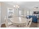 Light-filled dining area featuring a round table and chairs, adjacent to living room at 6001 - 5326 S Kings Hwy., Myrtle Beach, SC 29575