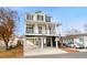 Two-story house with a large deck, attached garage, and ample parking at 6001 - 5326 S Kings Hwy., Myrtle Beach, SC 29575
