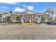Two-story brown building with stairs and parking at 712 Algonquin Dr. # A, Pawleys Island, SC 29585