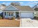 Charming one-story home with light blue siding, a two-car garage, and a landscaped front yard at 865 Summer Starling Pl., Myrtle Beach, SC 29577
