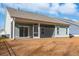 House exterior showcasing a screened porch and backyard at 865 Summer Starling Pl., Myrtle Beach, SC 29577