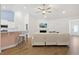 Open living room with a sectional sofa, hardwood floors, and a view of the kitchen at 865 Summer Starling Pl., Myrtle Beach, SC 29577