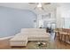 Relaxing living room with a white sectional sofa and a view into the dining area at 865 Summer Starling Pl., Myrtle Beach, SC 29577