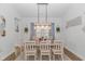 Dining room with table, chandelier, and natural light from a large window at 935 Piping Plover Ln., Myrtle Beach, SC 29577