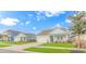 Light blue home with front yard landscaping and attached garage on a sunny day at 935 Piping Plover Ln., Myrtle Beach, SC 29577