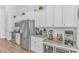 Modern kitchen featuring stainless steel appliances, white cabinets, and granite countertops at 935 Piping Plover Ln., Myrtle Beach, SC 29577